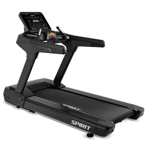 Photograph of a black Spirit Fitness treadmill in a studio setting, featuring a large digital console displaying metrics, a prominent red emergency stop button, and silver accents on the handrails